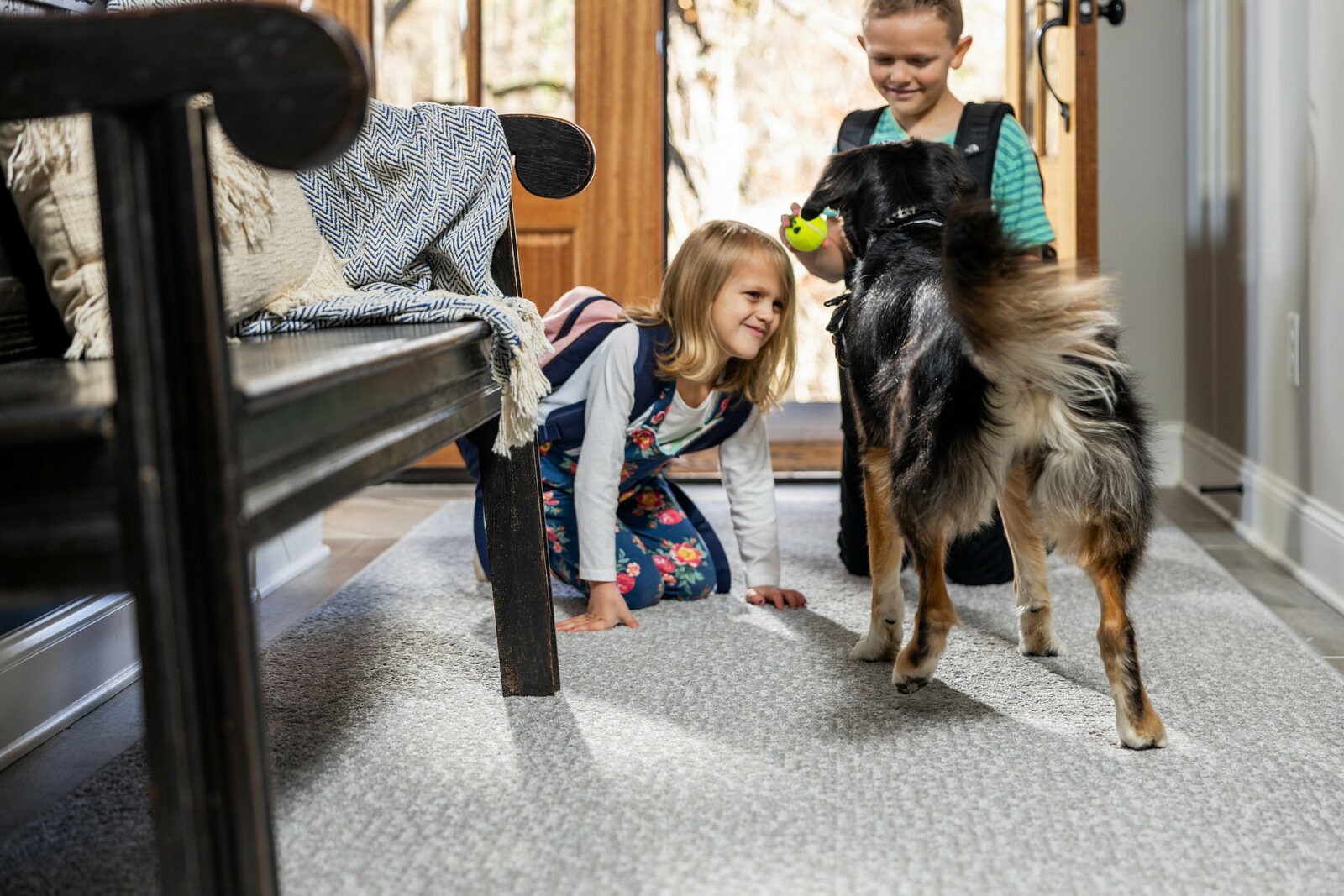 Kids plying with dog on carpet flooring | Staff Carpet