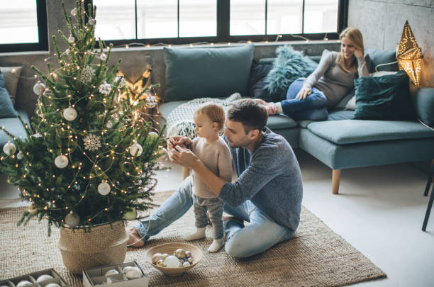 Father and daughter decorate a christmas tree | Staff Carpet